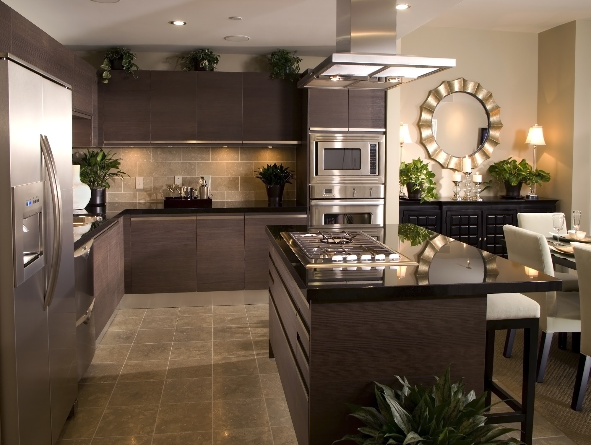 Modern kitchen island with stainless appliances and pendant lighting